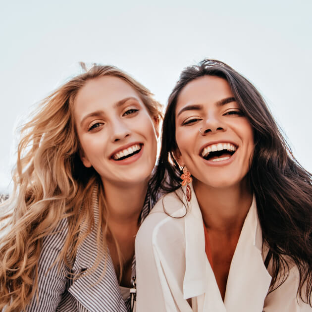 Two young woman outside and enjoying life.